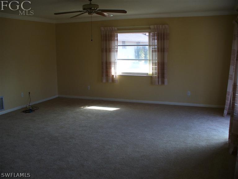 369 Westpark Road Lehigh Acres, FL 33936 - Photo 3 of 7 an empty room with a window