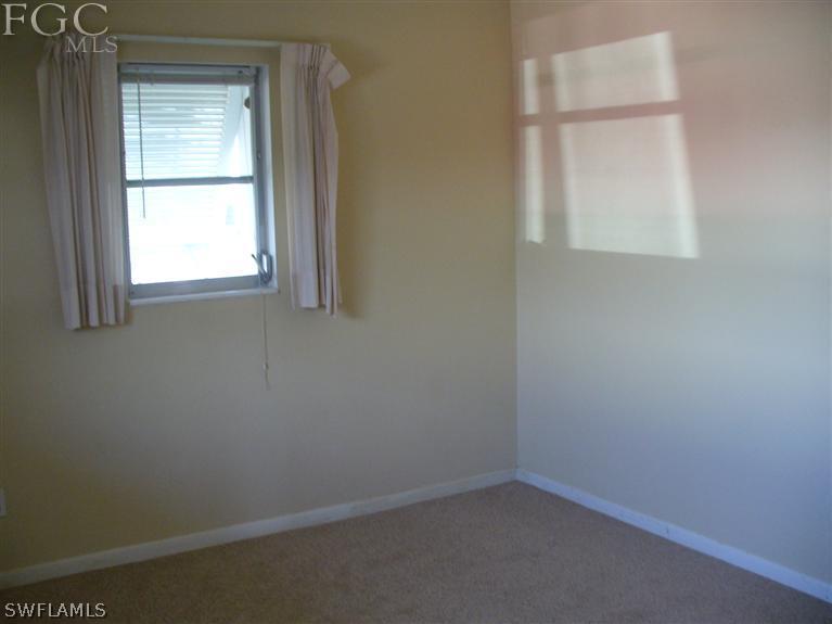369 Westpark Road Lehigh Acres, FL 33936 - Photo 6 of 7 an empty room with a window