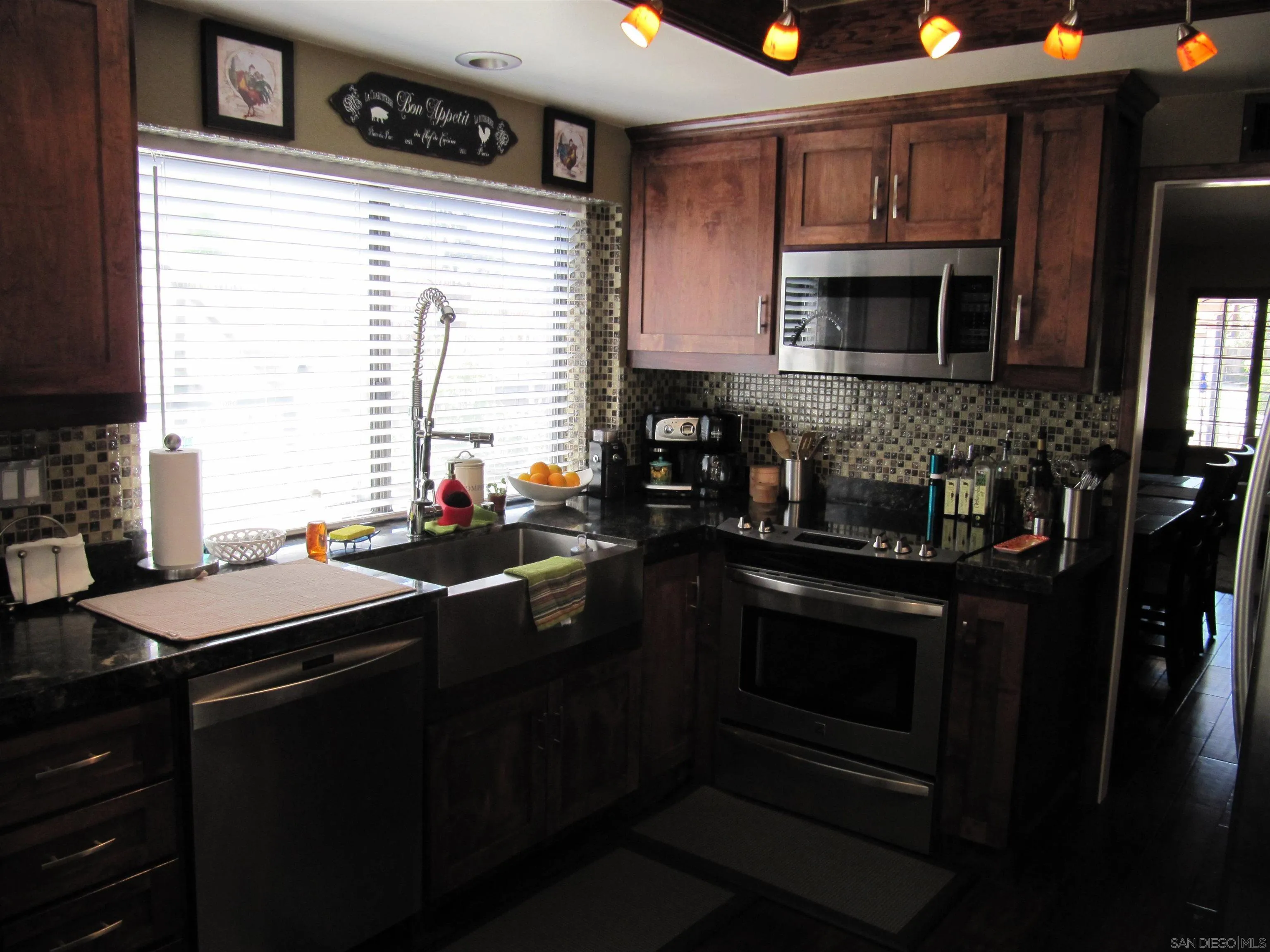 13236 Poway Hills Drive Poway, CA 92064 - Photo 7 of 19 a kitchen with stainless steel appliances granite countertop a stove a sink and a microwave