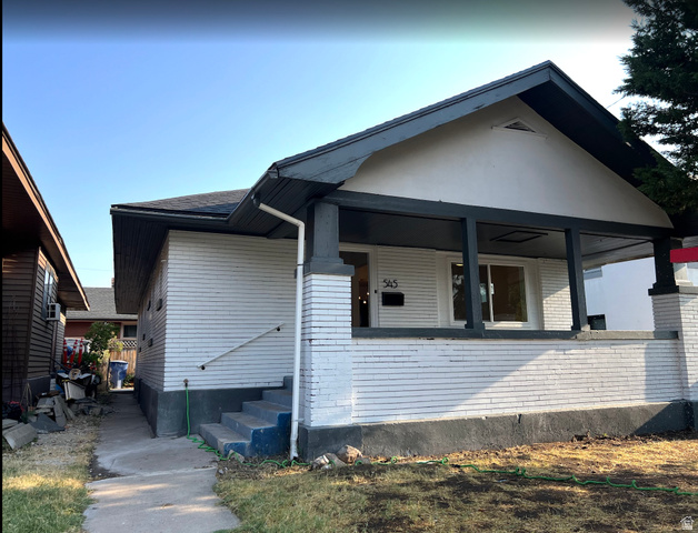 545 23rd Street Ogden, UT 84401 - Photo 1 of 28 Front facade featuring a covered porch, white siding, and a contrasting dark trim