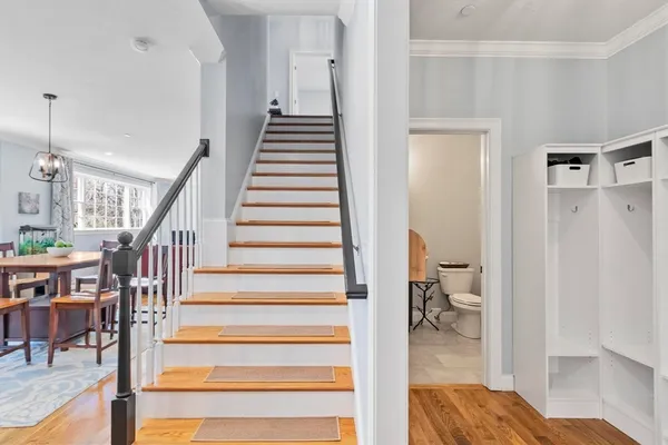 a view of entryway and hall with wooden floor