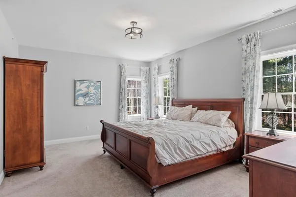 a bedroom with a bed lamp and window