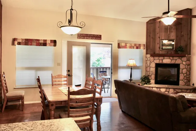 a living room with furniture a fireplace and a chandelier