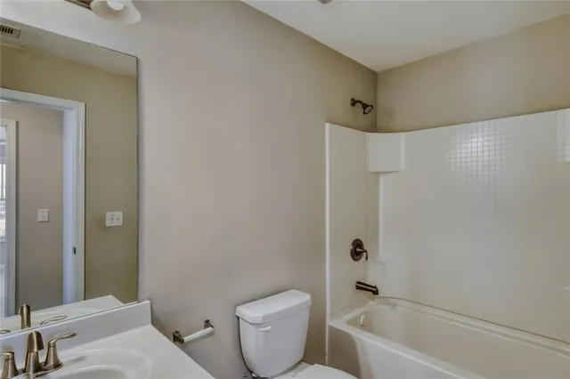 a bathroom with a toilet sink and bathtub