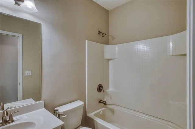a bathroom with a bathtub and a toilet