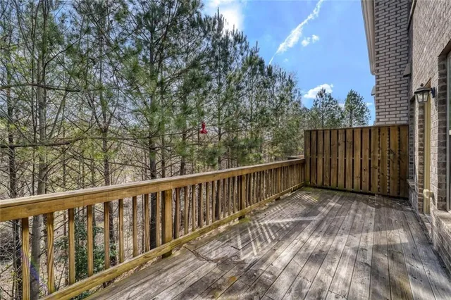 a balcony with wooden floor and fence