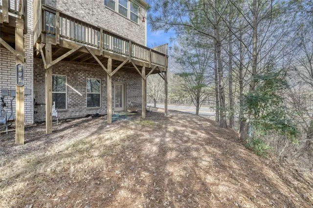 a view of a wooden house with a large tree