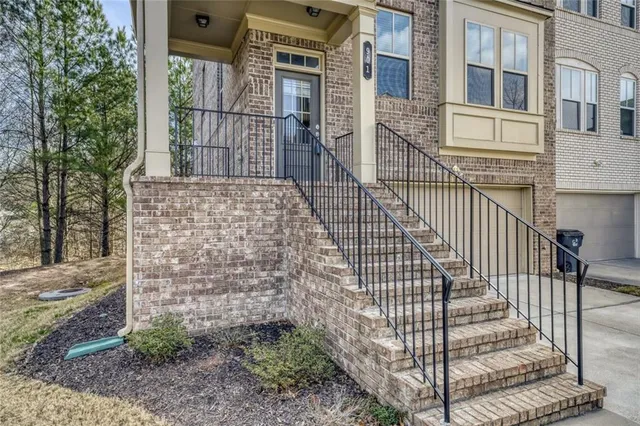 a view of a brick house with many windows