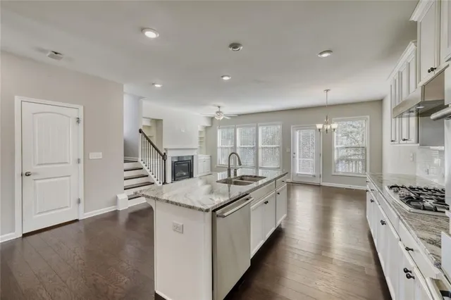 a kitchen with sink stove and refrigerator