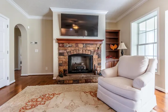 a kitchen with stainless steel appliances granite countertop a refrigerator a stove top oven a sink dishwasher and white cabinets with wooden floor