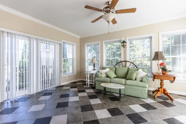 a kitchen with a sink stove cabinets and wooden floor