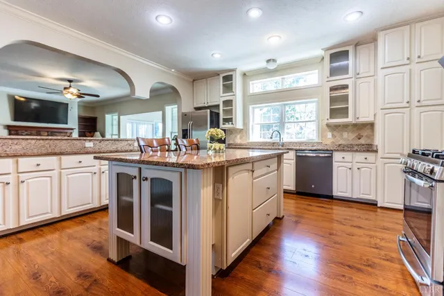 a kitchen with stainless steel appliances a refrigerator and a stove