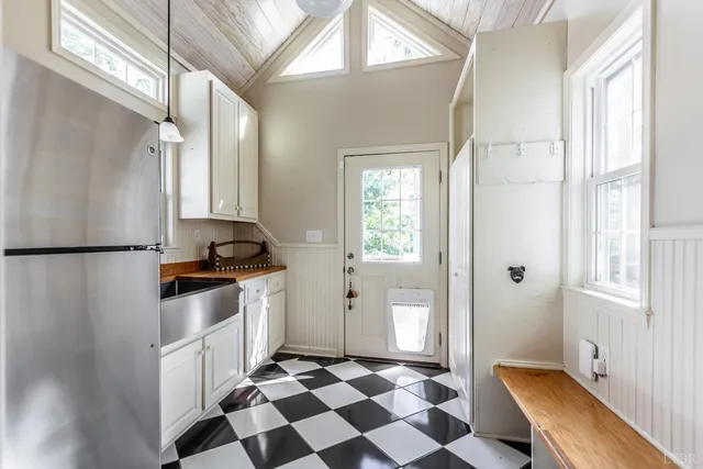 a bathroom with a granite countertop sink a mirror and shower