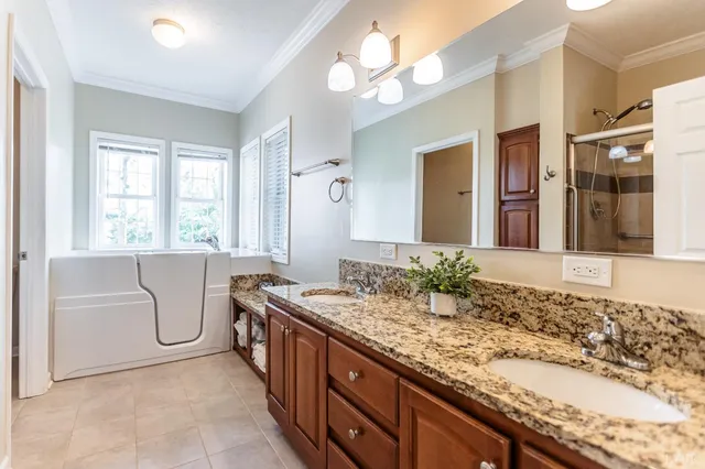 a spacious bedroom with a bed and a chandelier