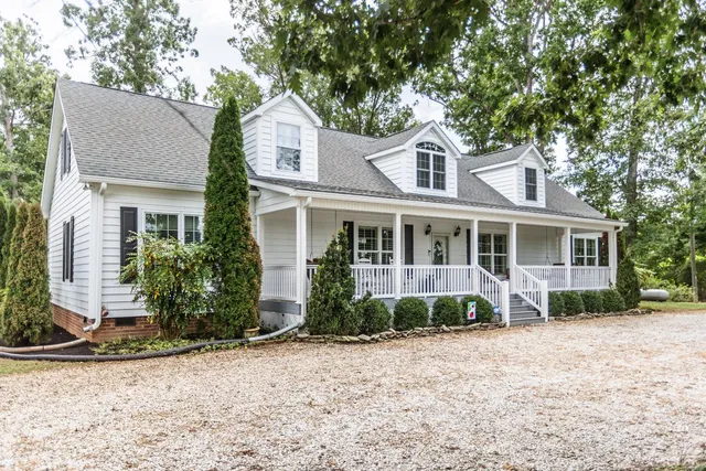 a front view of a house with a yard and potted plants