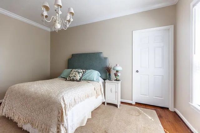 a white house that has a tree in front of the house