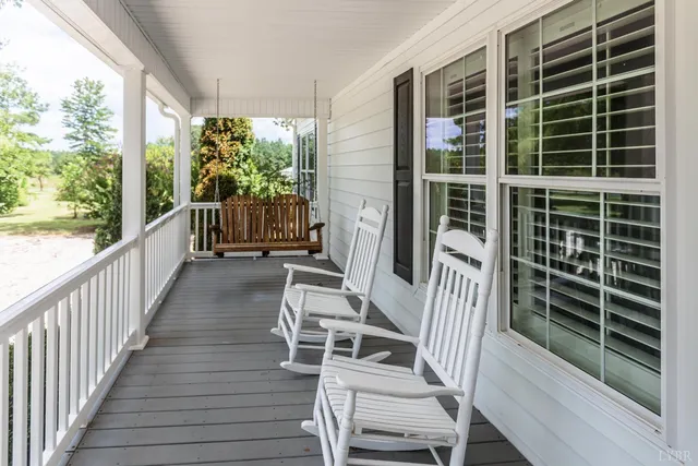 a view of a hallway with entryway wooden floor and front door