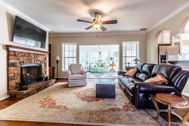 a living room with furniture and a floor to ceiling window