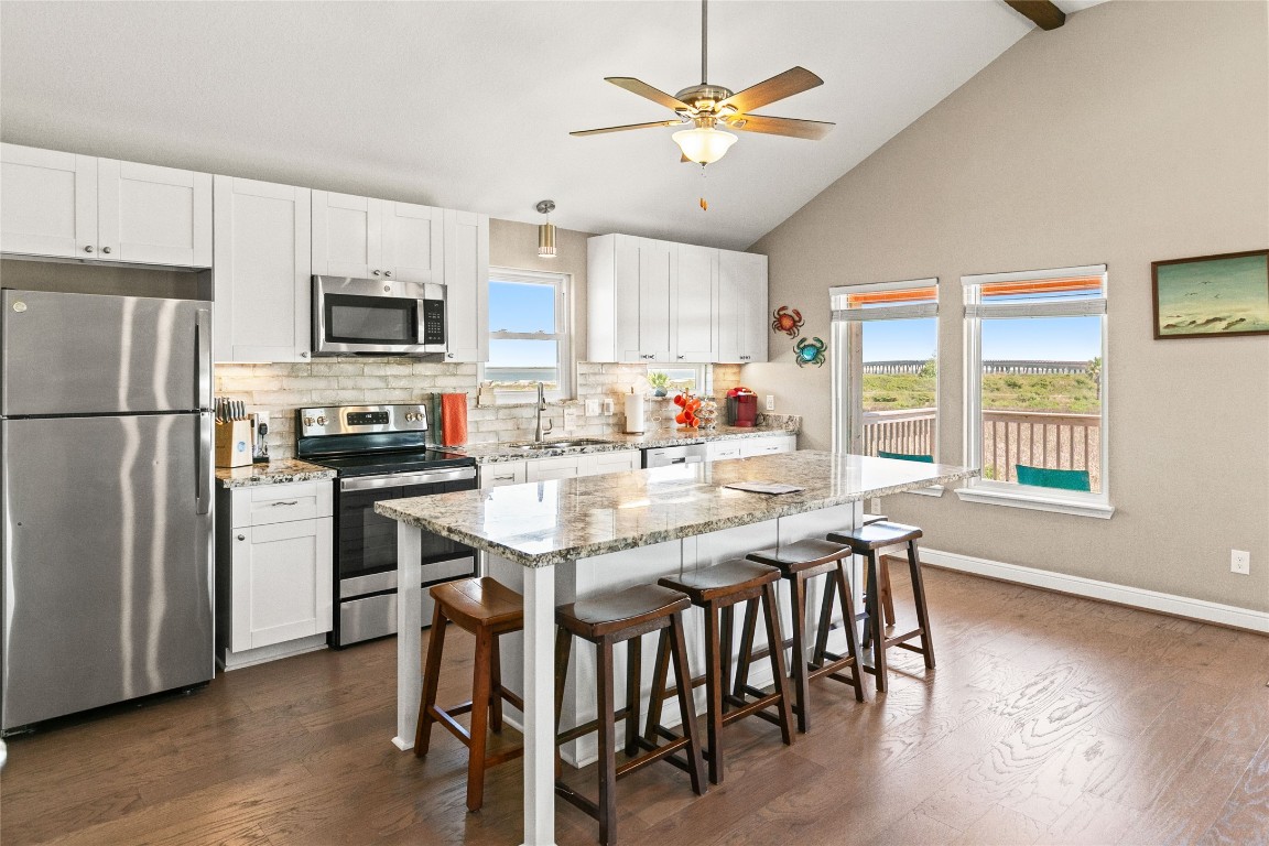 147 Pieces Of 8 Freeport, TX 77541 - Photo 7 of 33 a kitchen with stainless steel appliances granite countertop a dining table chairs refrigerator and microwave