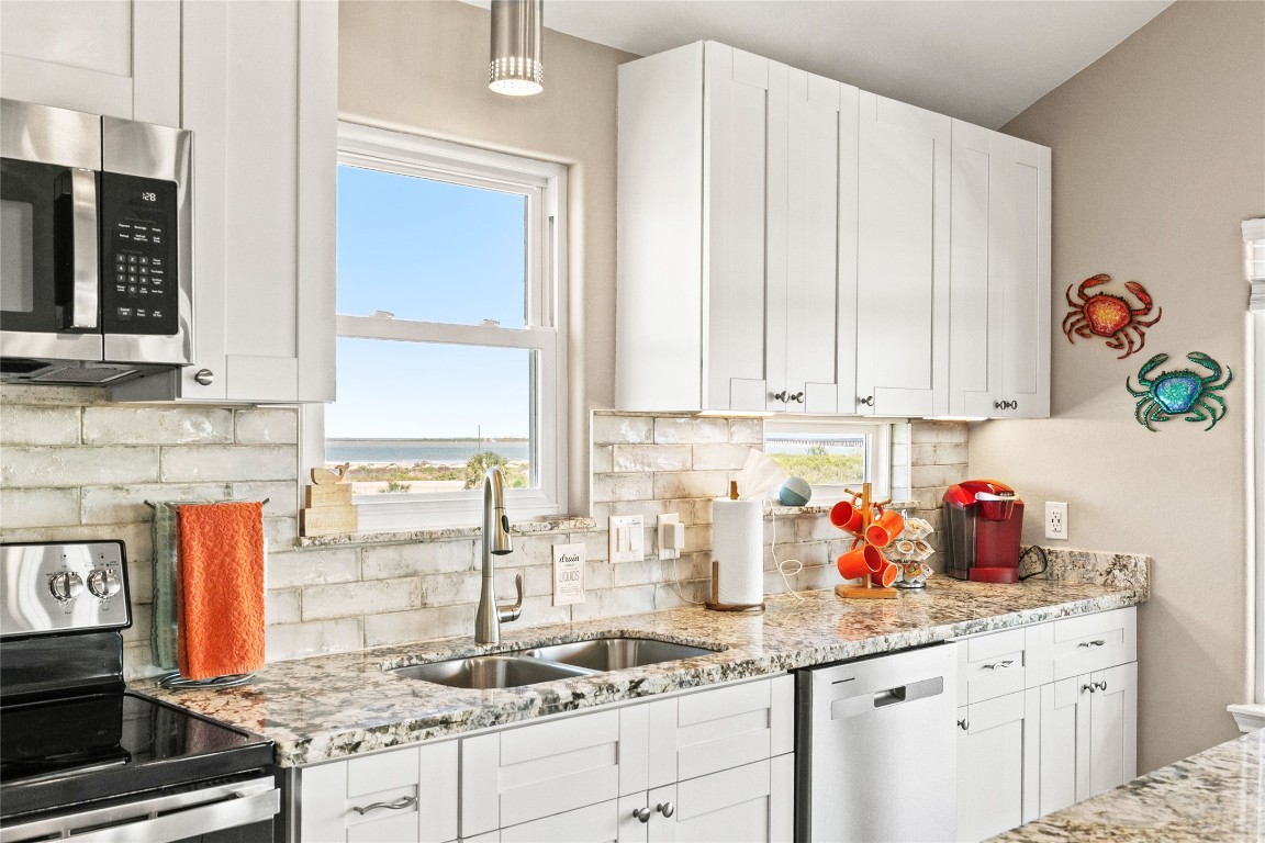 147 Pieces Of 8 Freeport, TX 77541 - Photo 8 of 33 a kitchen with stainless steel appliances granite countertop a sink stove and cabinets