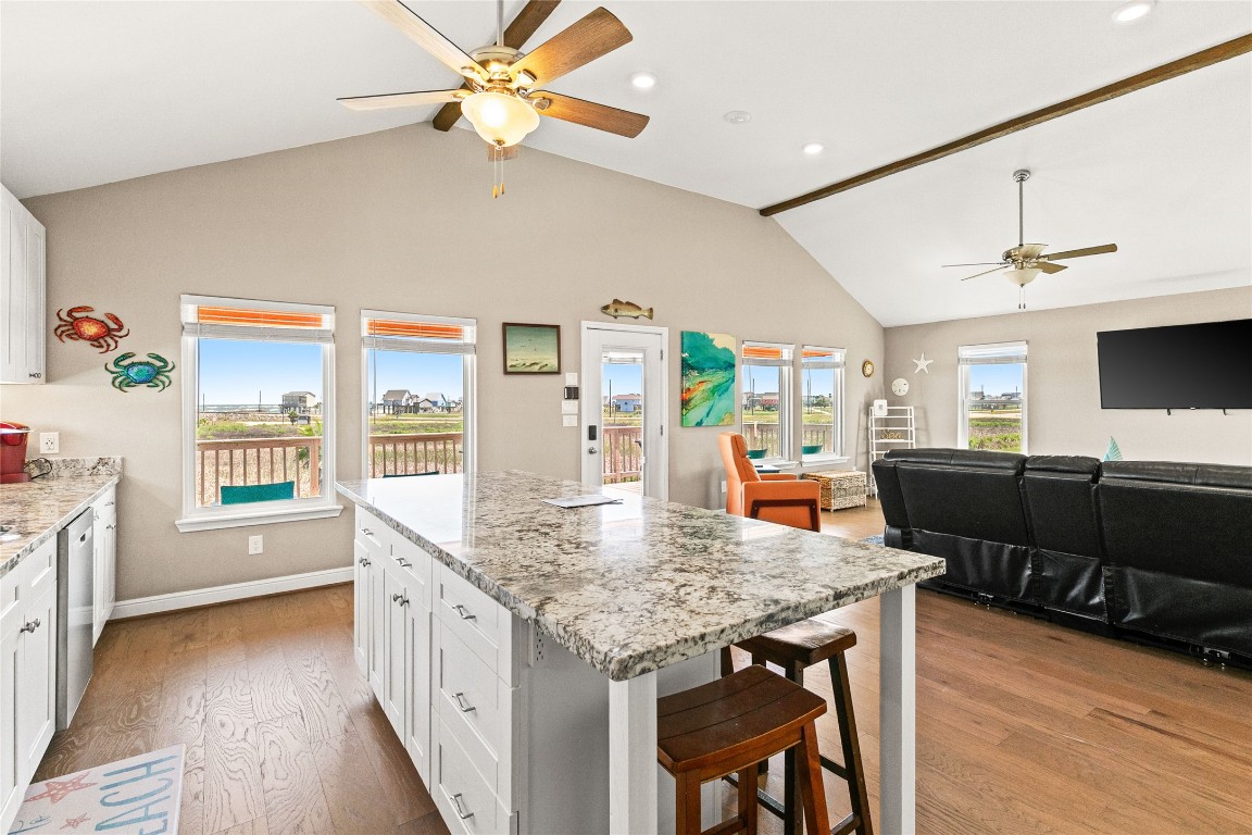 147 Pieces Of 8 Freeport, TX 77541 - Photo 10 of 33 a kitchen with granite countertop a stove a sink a dining table and chairs with wooden floor