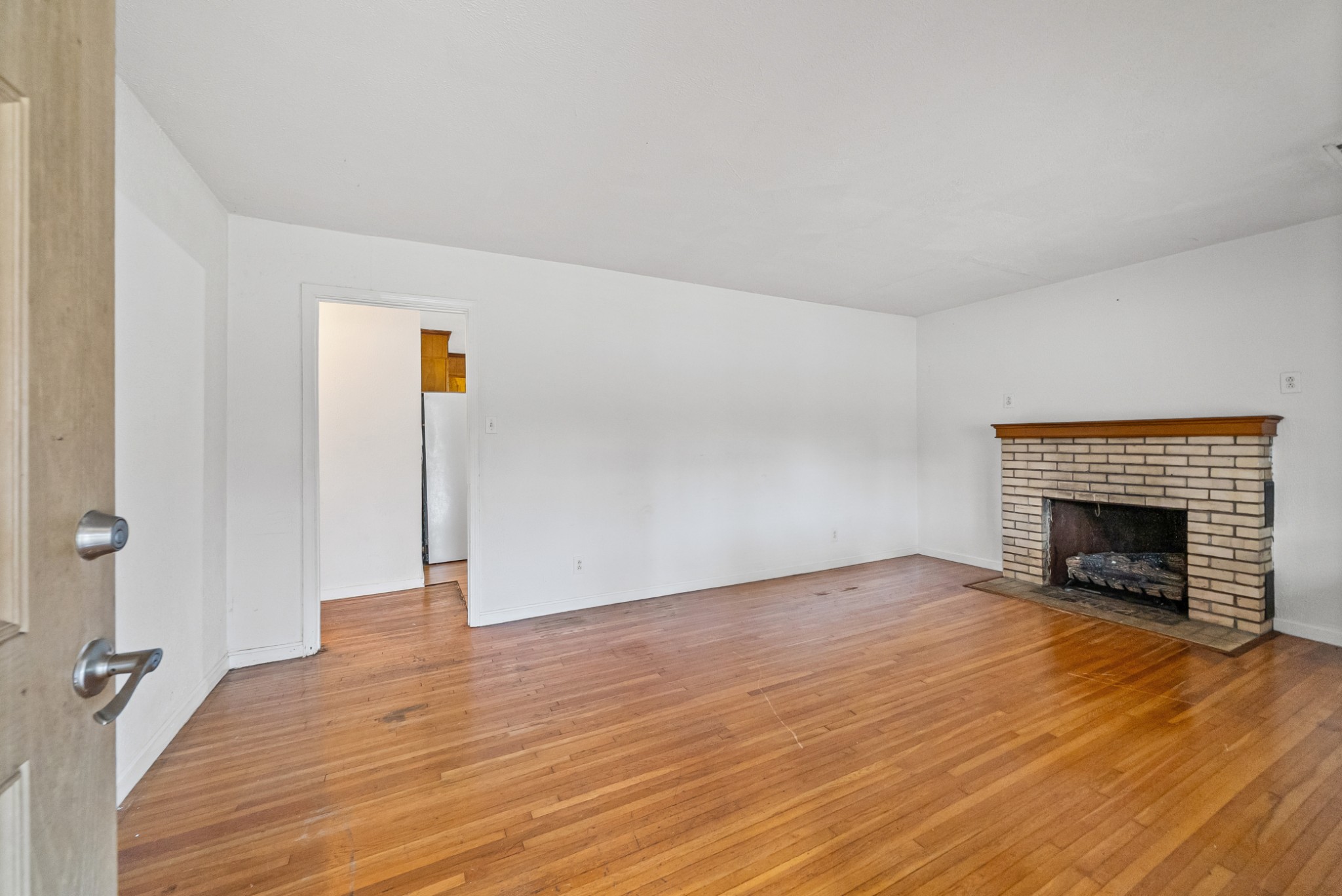 1667 McWhorter Road Cunningham, TN 37052 - Photo 5 of 35 a view of empty room with wooden floor and fireplace