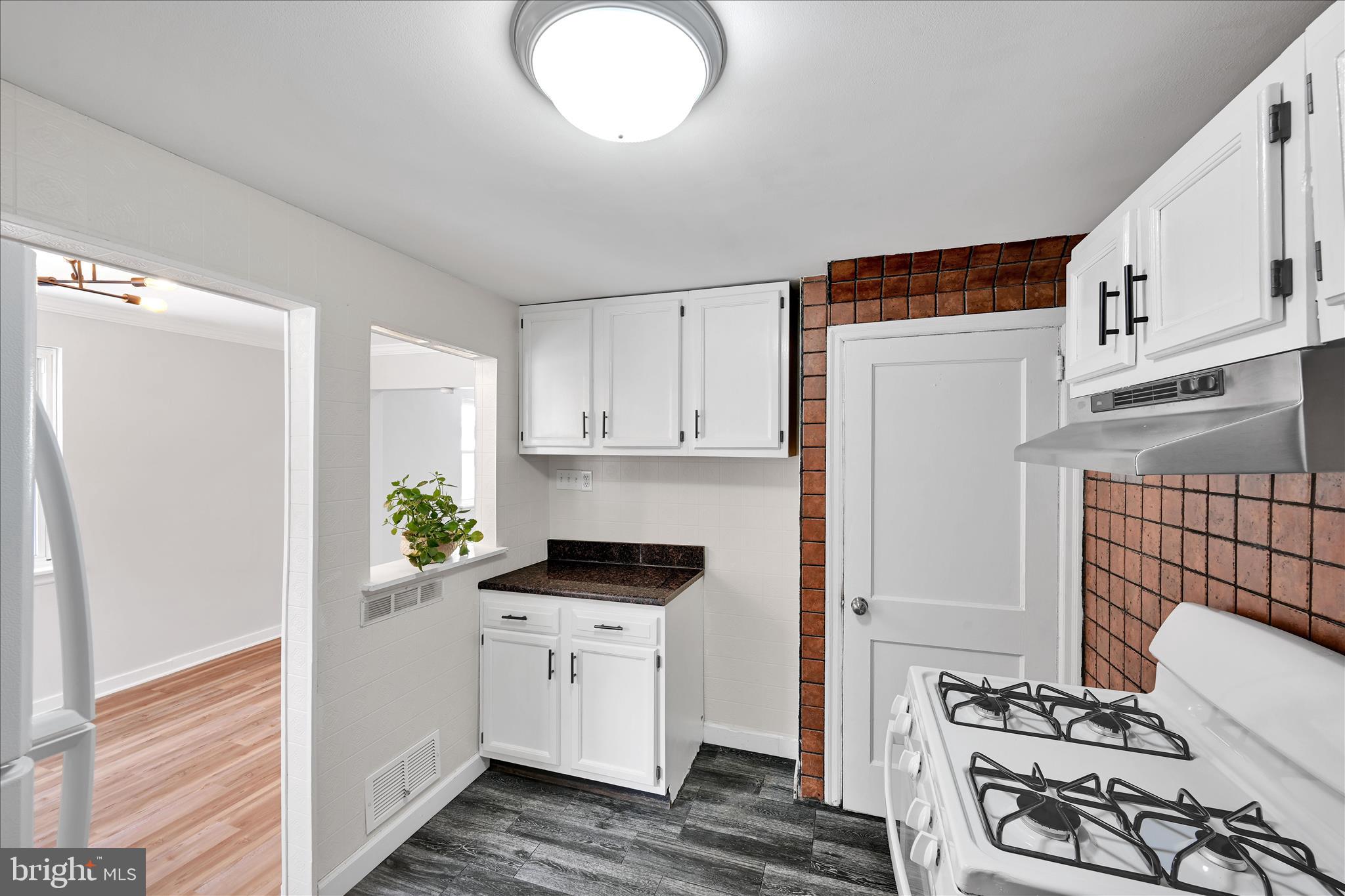 716 South Franklin Street Lancaster, PA 17602 - Photo 15 of 35 a kitchen with stainless steel appliances a white stove top oven and a refrigerator