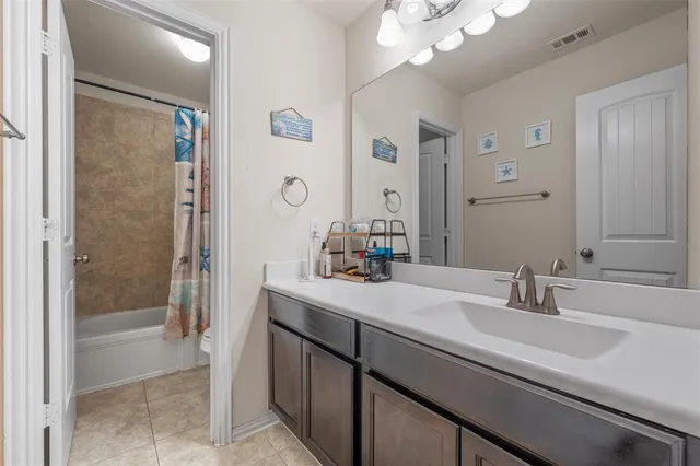 a bathroom with a sink a large mirror and a shower