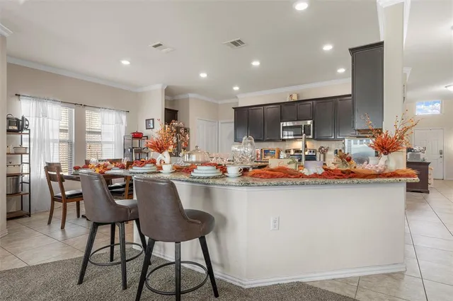a kitchen with a dining table chairs and a counter top space