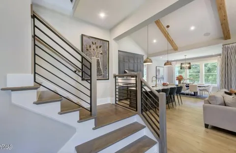 a view of a livingroom with furniture and staircase