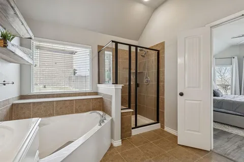 a bathroom with a bathtub and a shower