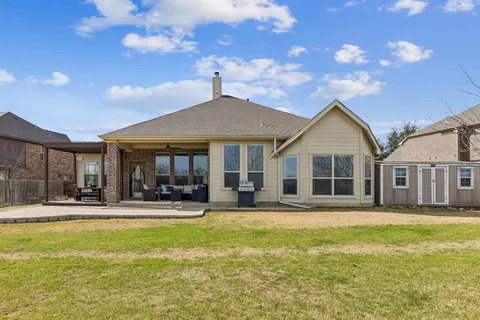a front view of a house with swimming pool and porch with furniture
