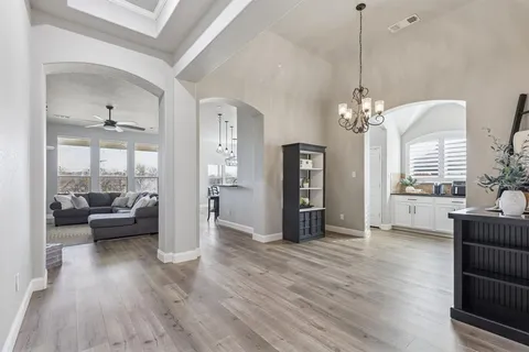 a living room with furniture and a chandelier