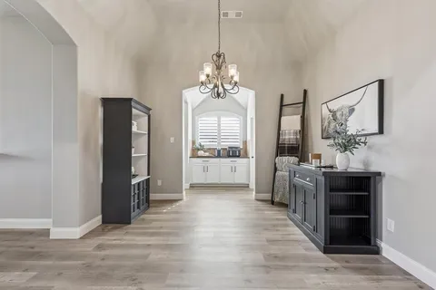a view of a big room with wooden floor windows and a kitchen