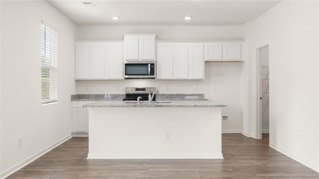 621 Lobelia Way Locust Grove, GA 30248 - Photo 11 of 42 a kitchen with appliances a sink and a microwave