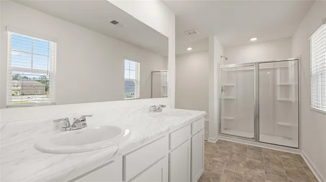a bathroom with a glass shower door