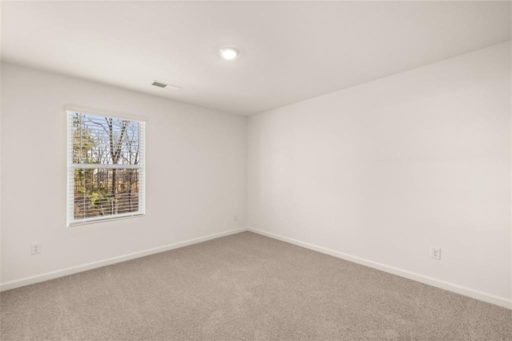 621 Lobelia Way Locust Grove, GA 30248 - Photo 24 of 42 an empty room with a window