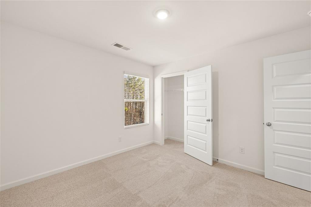 621 Lobelia Way Locust Grove, GA 30248 - Photo 28 of 42 an empty room with windows and closet