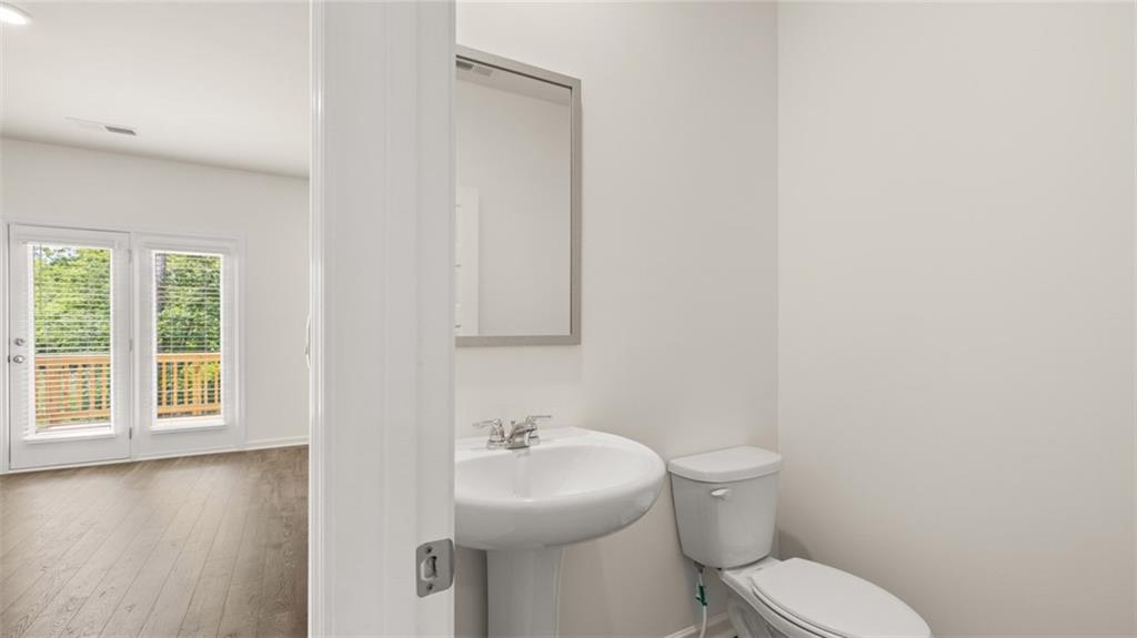 621 Lobelia Way Locust Grove, GA 30248 - Photo 31 of 42 a white toilet sitting next to a bathroom sink