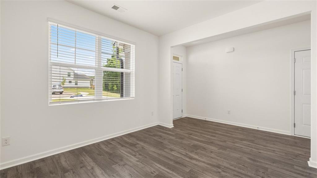 621 Lobelia Way Locust Grove, GA 30248 - Photo 32 of 42 a view of an empty room with wooden floor and a window