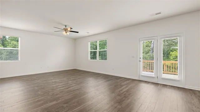 wooden floor in an empty room with a window