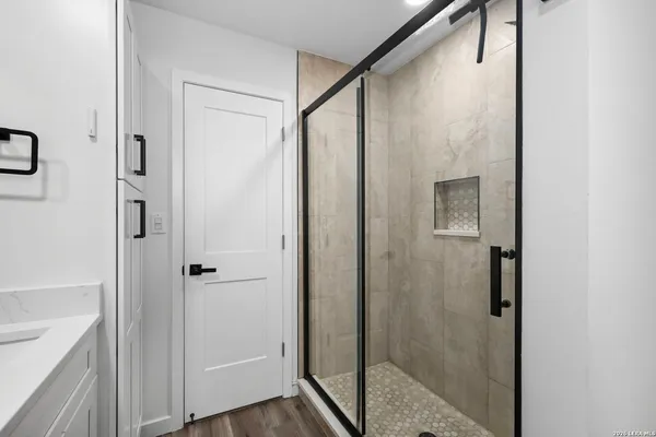 a bathroom with a glass shower door