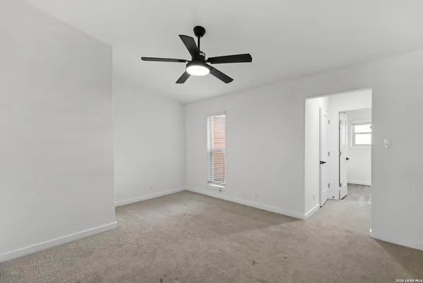 a view of a livingroom with a ceiling fan and window
