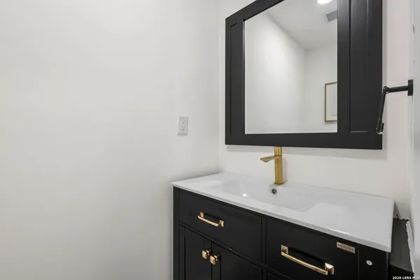 a bathroom with a sink and a mirror