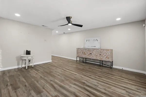 a view of an empty room and wooden floor