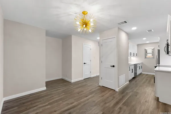 a view of an entryway of a room and wooden floor