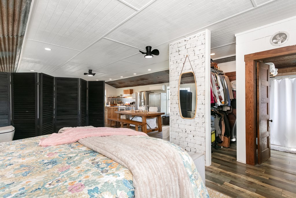 3527 Old Harper Road Fredericksburg, TX 78624 - Photo 14 of 43 a large bedroom with a large bed and a large mirror