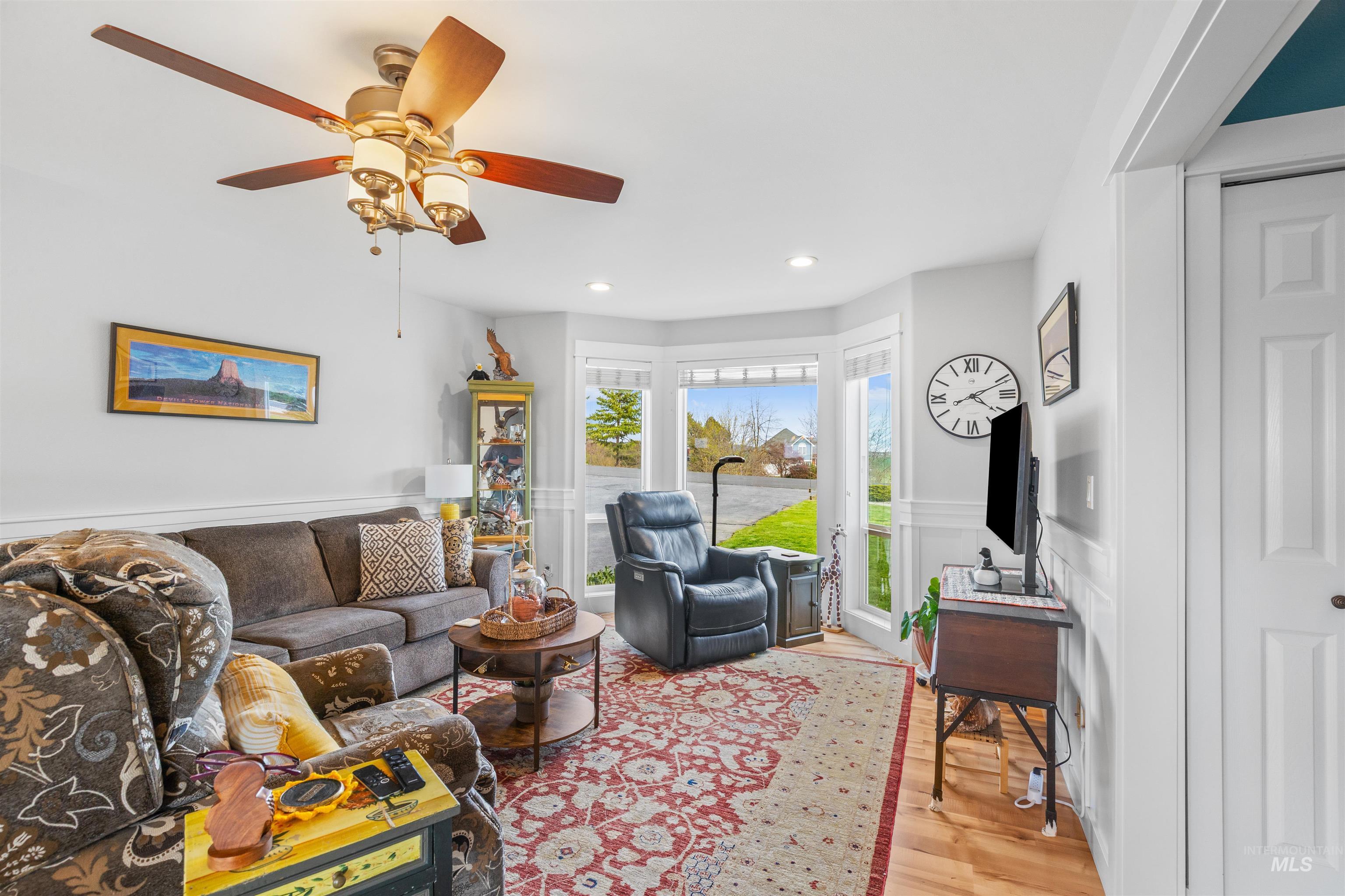 2435 Arborcrest Road Moscow, ID 83843 - Photo 18 of 48 Living room featuring a wainscoted wall, light wood-style flooring, recessed lighting, and ceiling fan