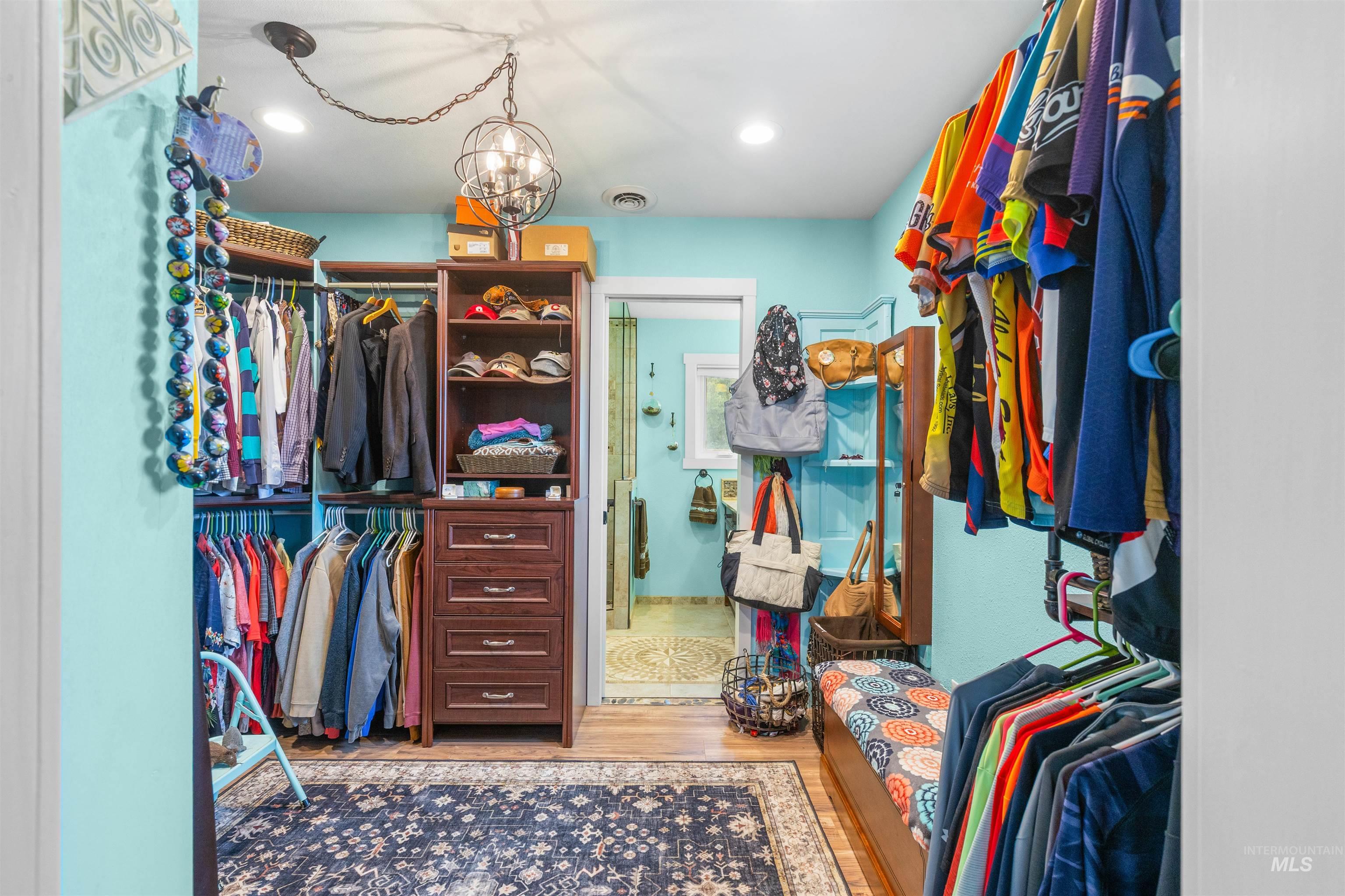 2435 Arborcrest Road Moscow, ID 83843 - Photo 20 of 48 Walk in closet featuring light wood finished floors and suspended lighting