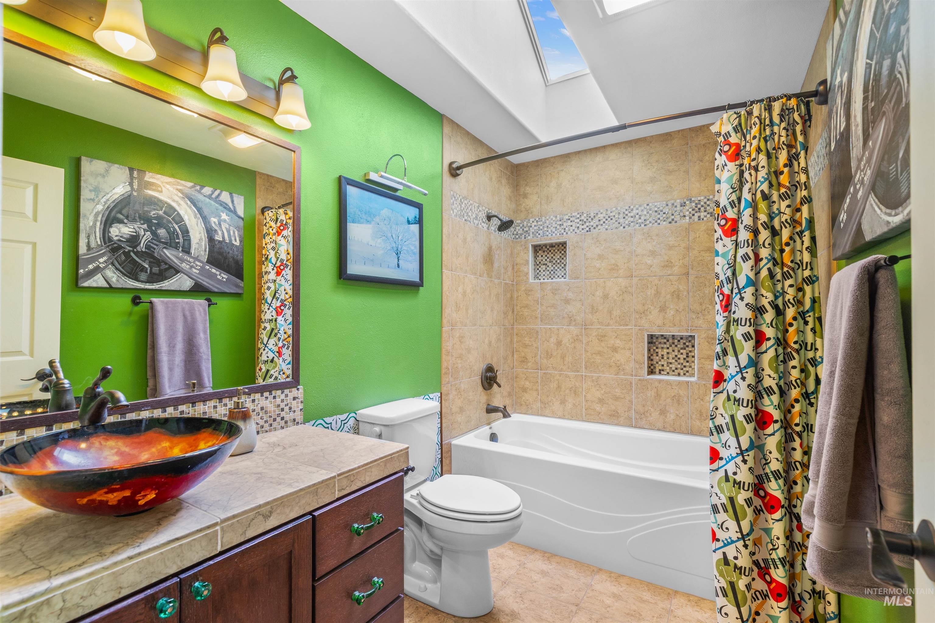 2435 Arborcrest Road Moscow, ID 83843 - Photo 24 of 48 Bathroom with vanity, a skylight, and shower / tub combo with curtain
